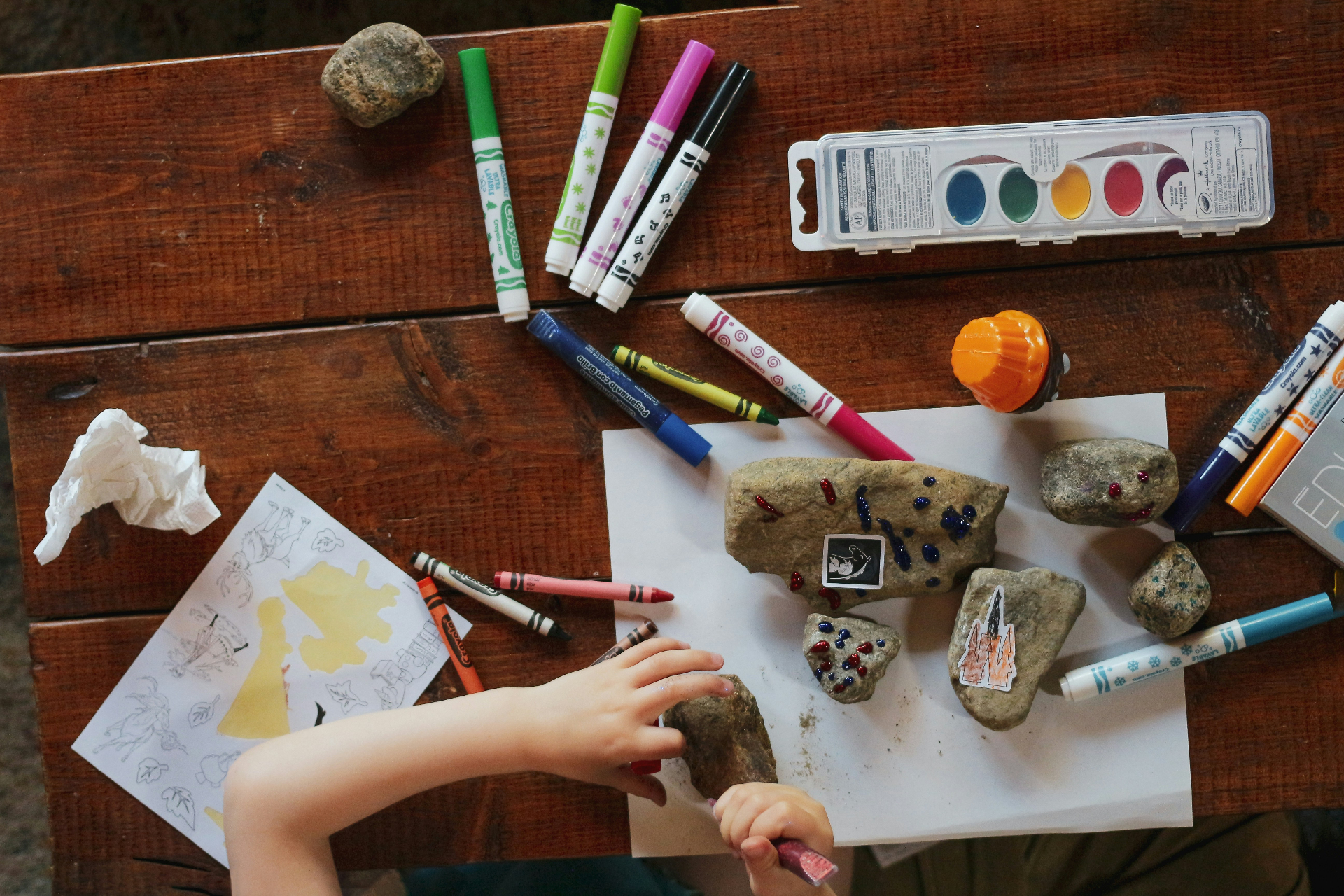 Hands-on craft activity with rocks and markers